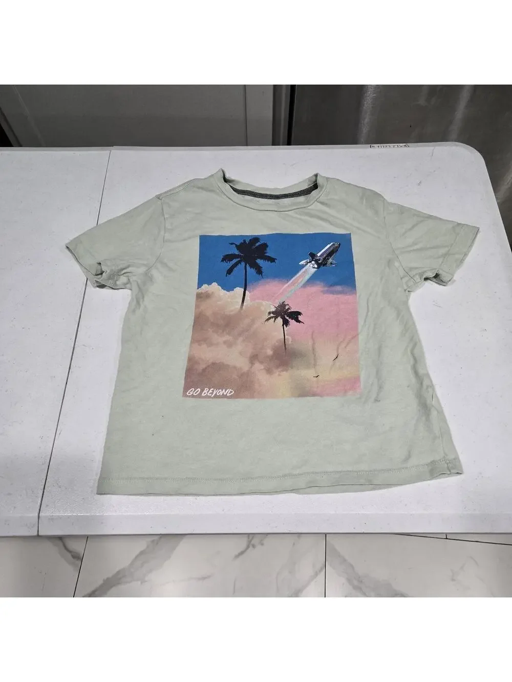 -Light green Old Navy graphic tee with palm trees and a rocket